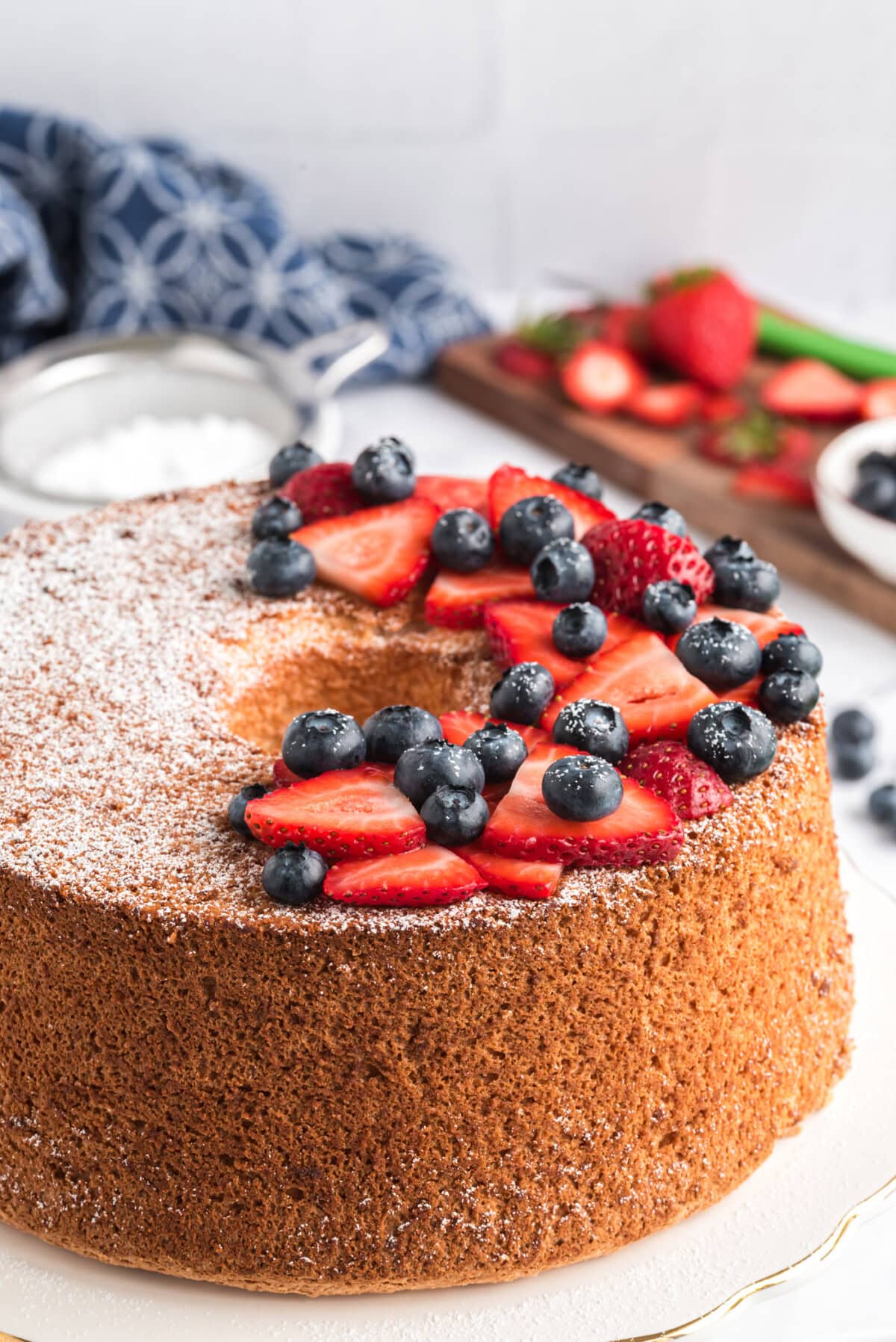 Angel Food Cake topped with powdered sugar and berries