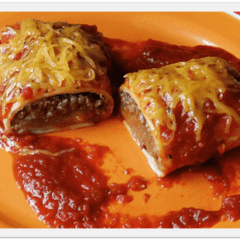 A close up photo of a Taco Bell enchirito copycat cut in half resting on a plate.