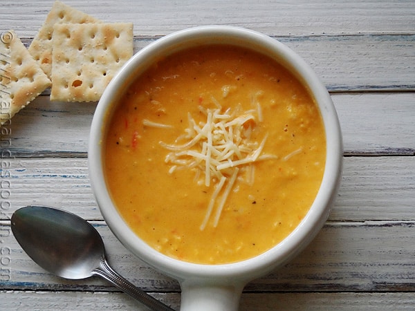 An overhead photo of a bowl of creamy white cheddar corn soup.