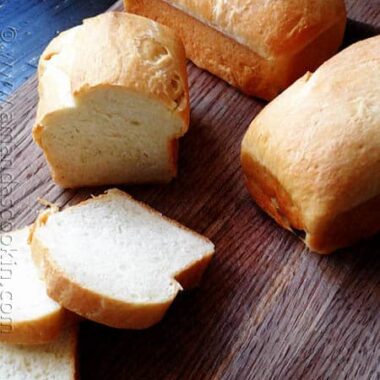 A photo of a sliced Amish white bread mini loaves.