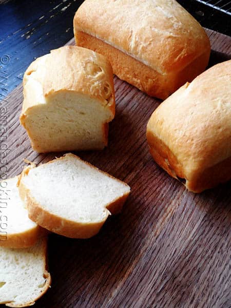 A photo of a sliced Amish white bread mini loaves.