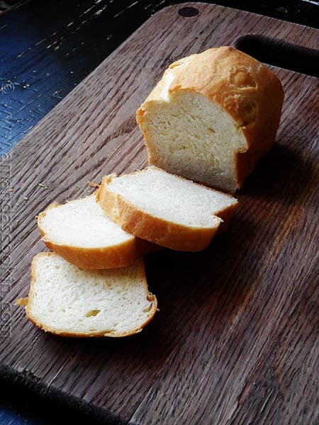 A photo of a sliced Amish white bread mini loaf.