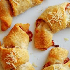 A close up photo of pizza crescent roll ups.