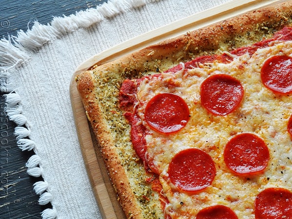 A close up photo of garlic bread crusted classic pizza.