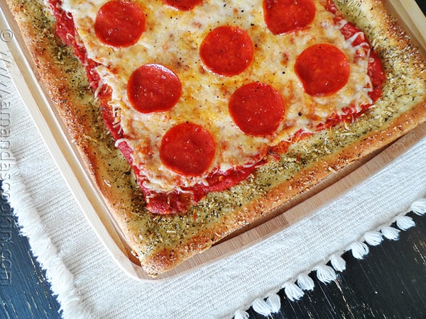 A close up overhead photo of garlic bread crusted classic pizza.