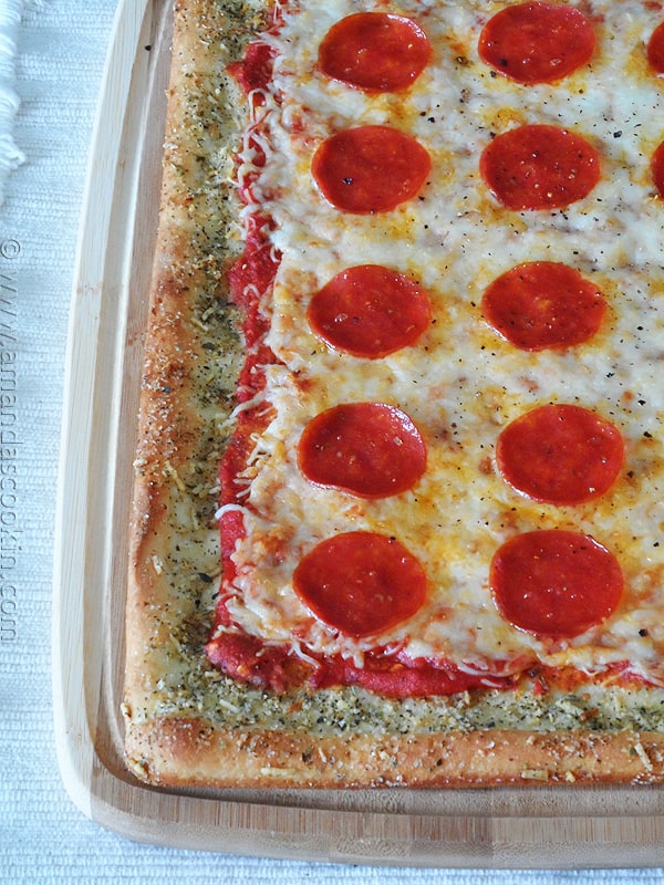 A close up photo of garlic bread crusted classic pizza.