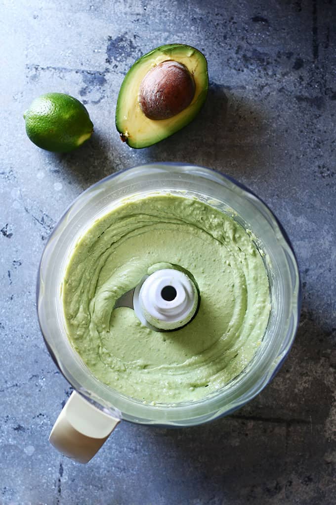 An overhead photo of creamy avocado in food processor.