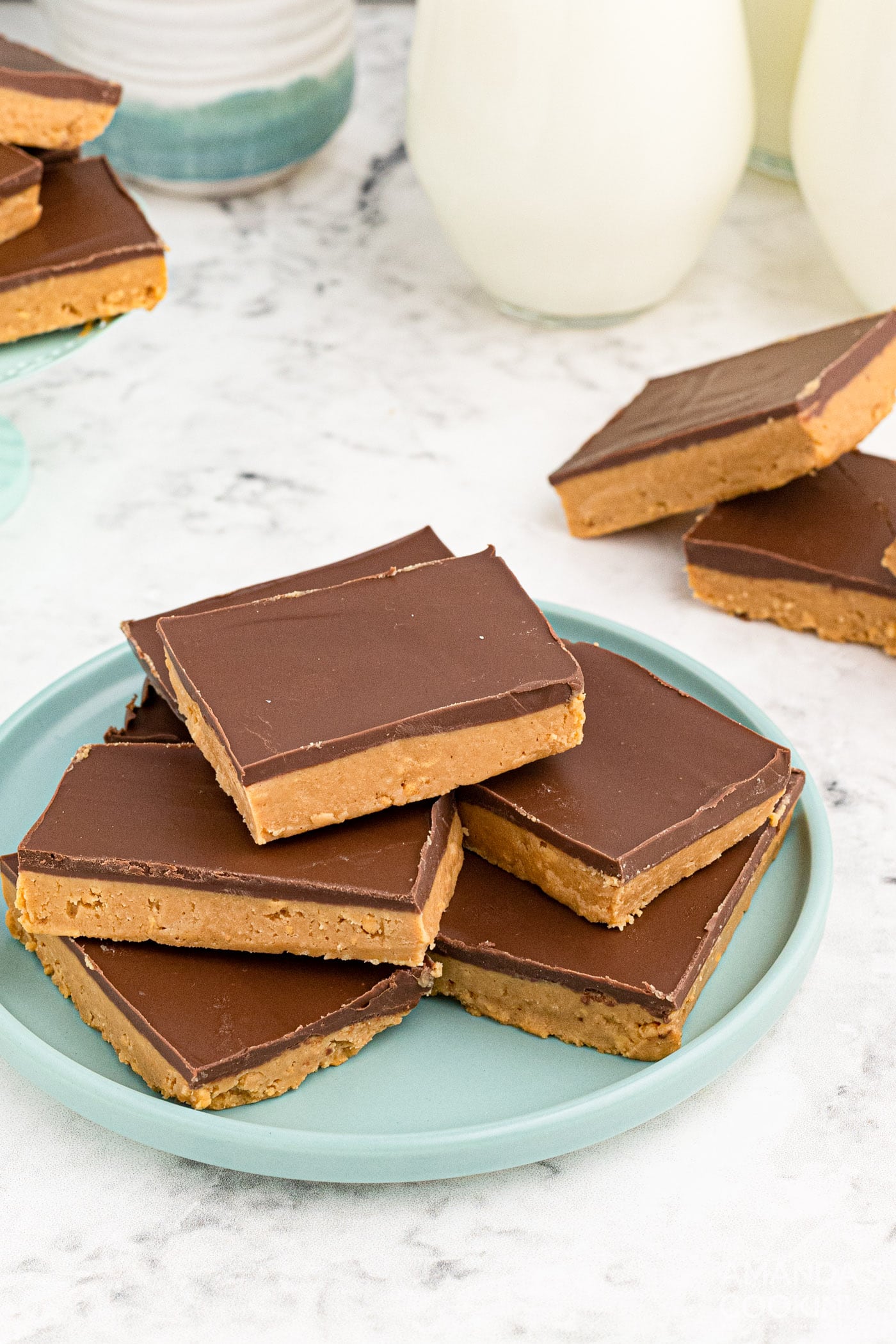 peanut butter bars stacked on a plate