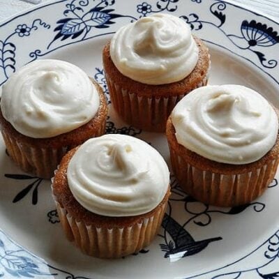 A close up photo of four time saver carrot cupcakes on a plate.
