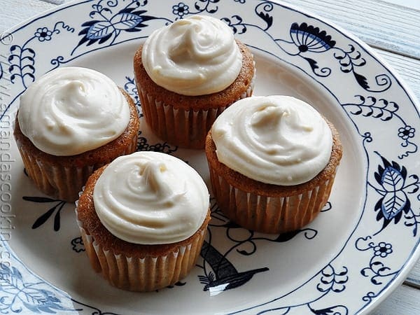 A close up photo of four time saver carrot cupcakes on a plate.