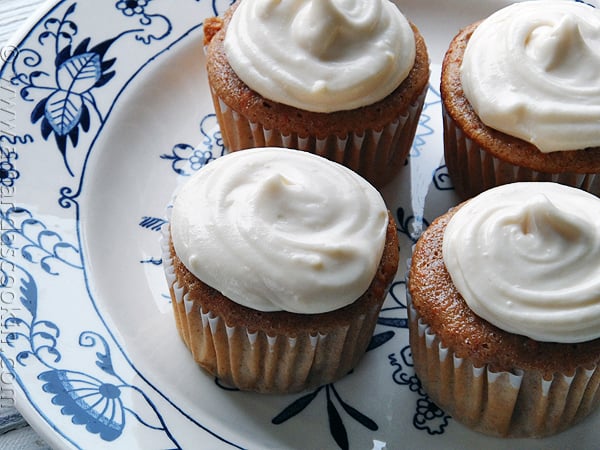 A close up photo of four time saver carrot cupcakes on a plate.