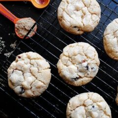 An overhead photo of cherry white chocolate chip cookies on a cooling rack.