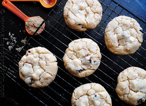 An overhead photo of cherry white chocolate chip cookies on a cooling rack.