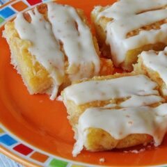 A close up photo of tropical dream dessert bars on an orange plate.