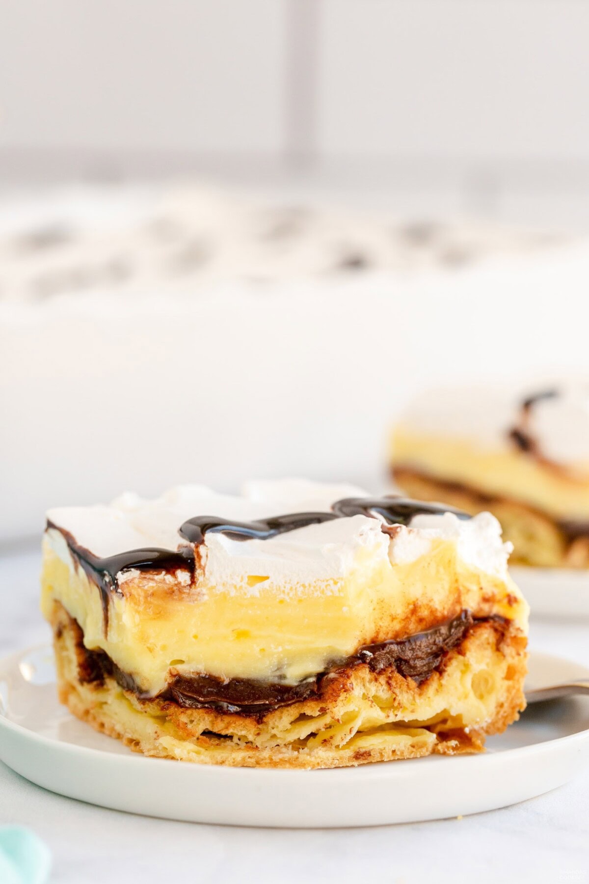 slice of Cream Puff Chocolate Eclair Cake on plate