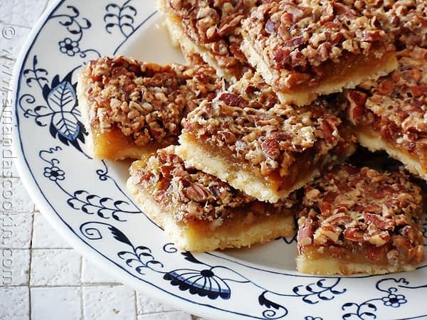 A close up overhead photo of pecan pie bars on a plate.