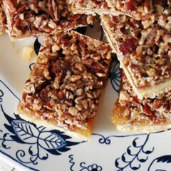 A close up overhead photo of pecan pie bars on a plate.