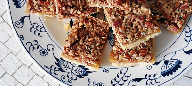 A close up overhead photo of pecan pie bars on a plate.