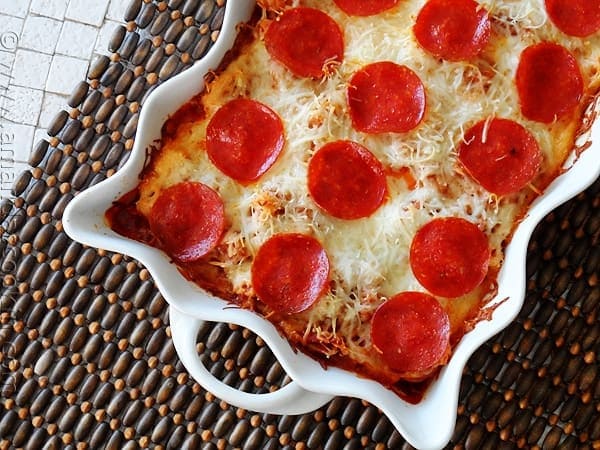 A close up photo of a sausage and pepperoni pizza casserole.