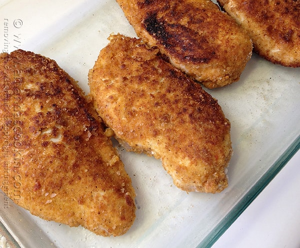 A close up photo of oven fried chicken breasts.