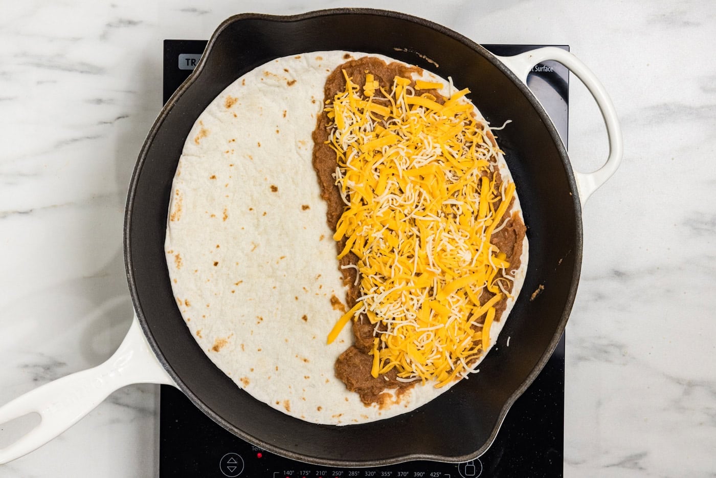 beans and cheese on tortilla