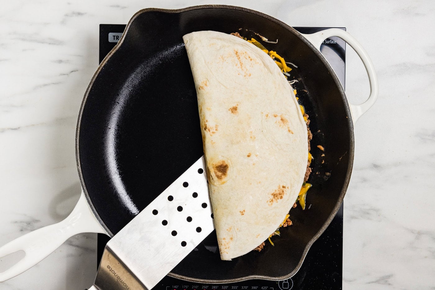 flipping quesadilla in skilet