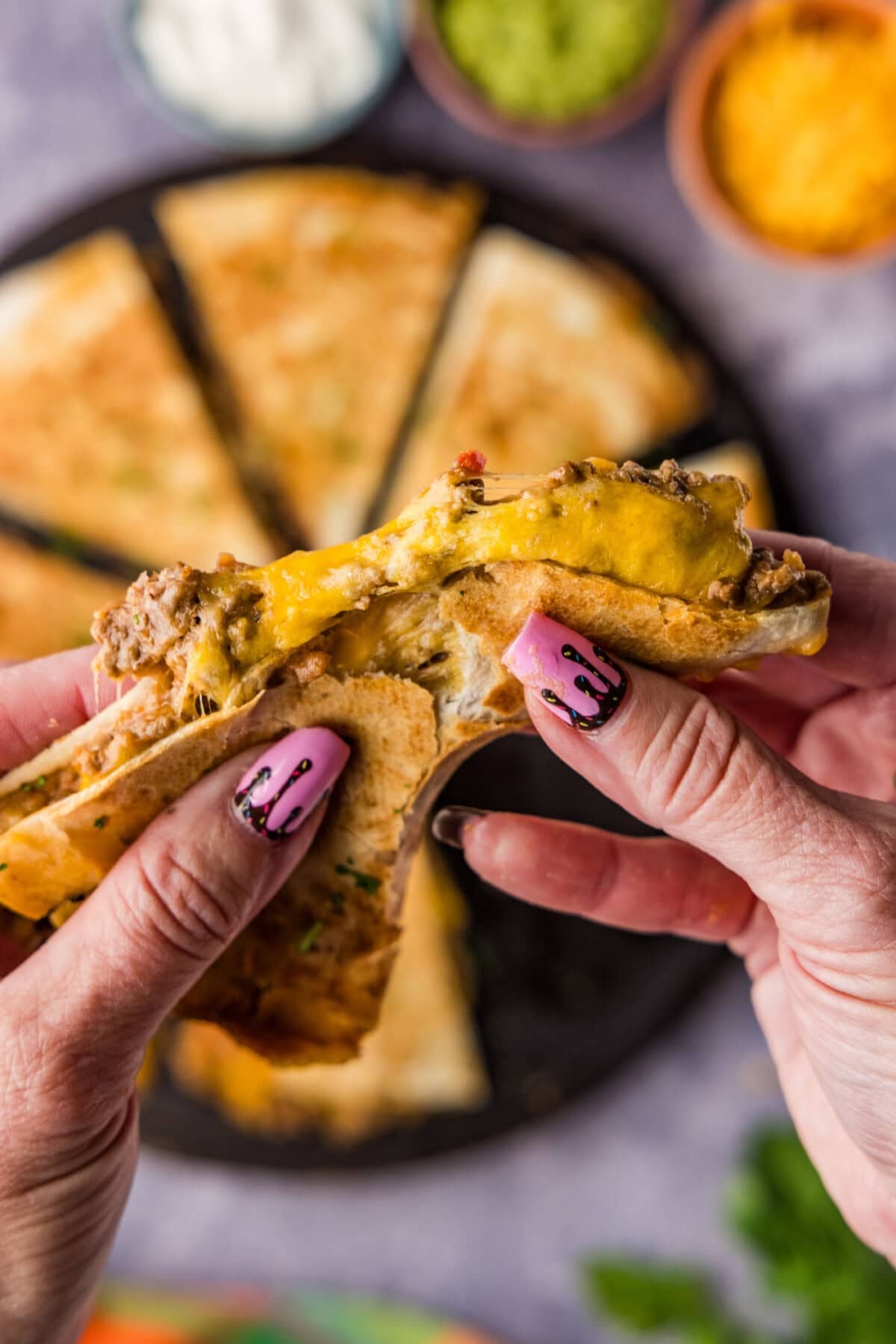 hand holding Beef and Bean Quesadillas