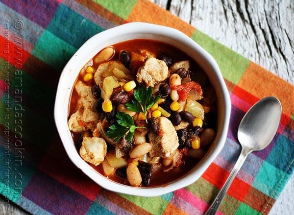 An overhead photo of a bowl of chicken chili with black beans and corn.