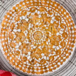 overhead view of Merryfield Apple Cake with doily decoration