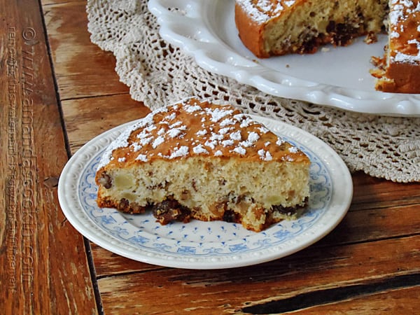 A photo of a slice of Merryfield apple cake on a decorative white and blue plate. 