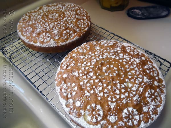 A photo of two Merryfield apple cakes with decorative powdered sugar on top.