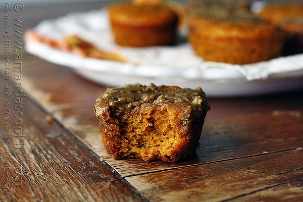 A close up photo of a half eaten pumpkin mini cake with cinnamon streusel topping.