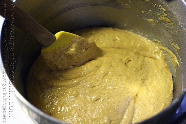 A photo of a spatula mixing the cake batter in a mixing bowl.