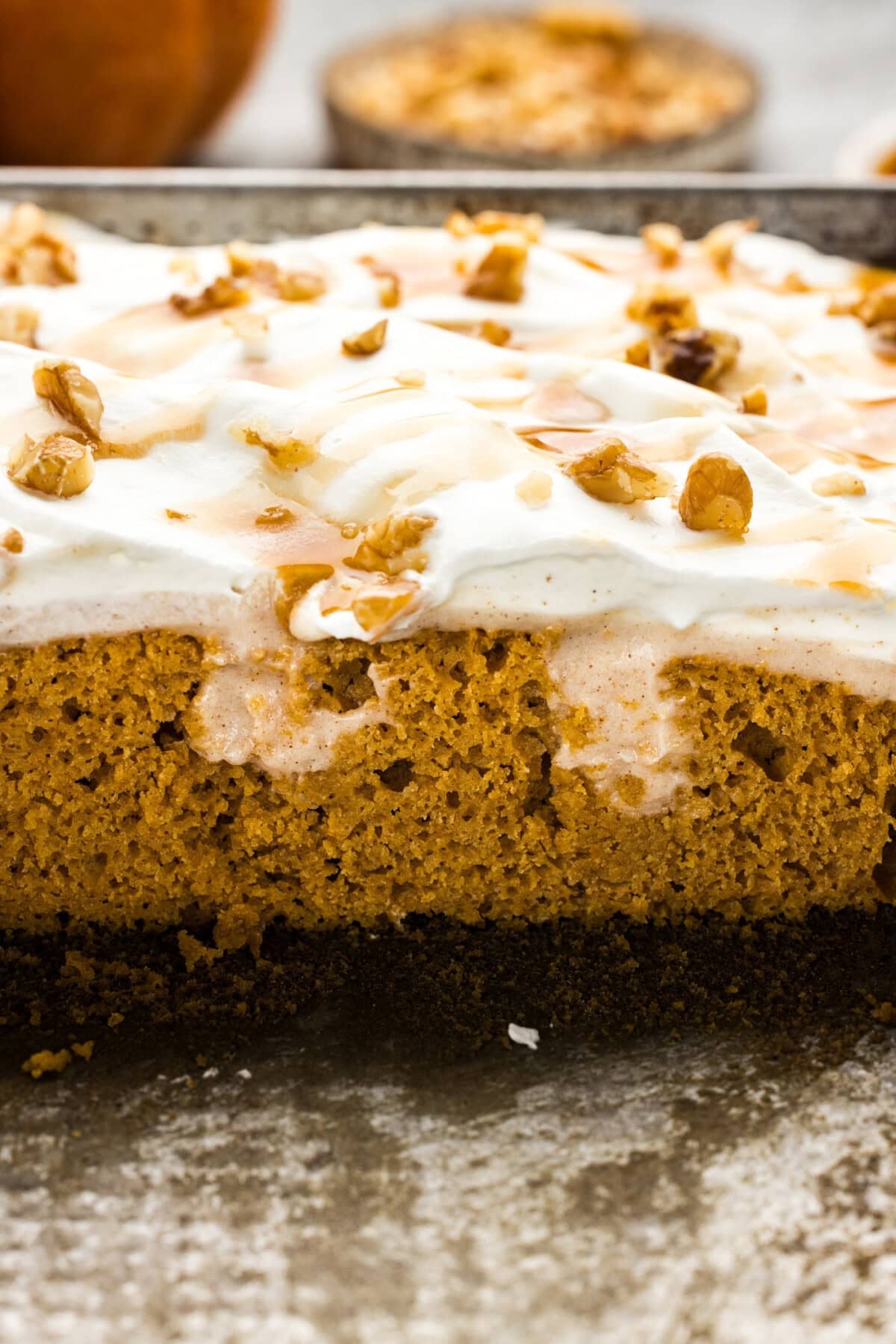 pumpkin pudding poke cake with slices out of it showing the pudding