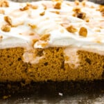 pumpkin pudding poke cake with slices out of it showing the pudding
