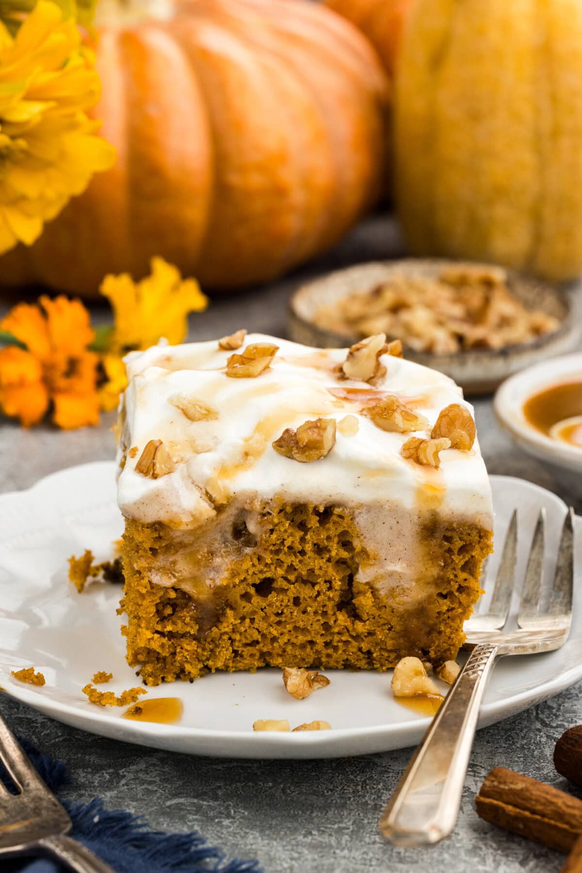 slice of pumpkin poke cake with pudding on a white plate