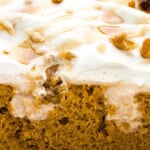 close up of slice of pumpkin pudding poke cake