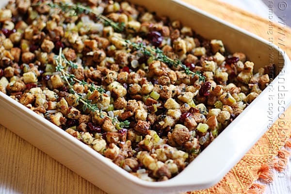 A close up of a pan of stuffing with parsley, sage, rosemary and thyme.