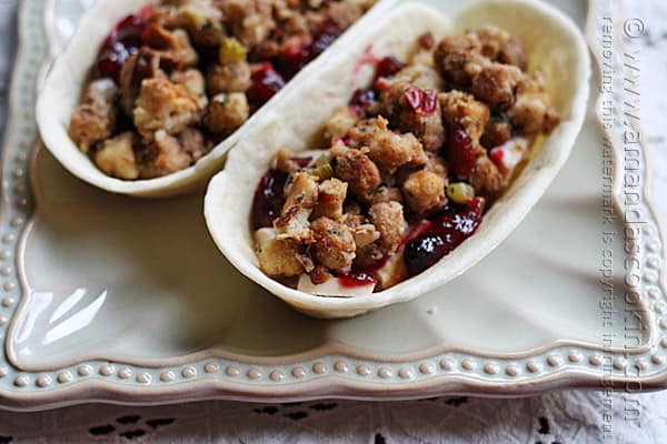 A close up of turkey, cranberry and stuffing pockets on a decorative platter.