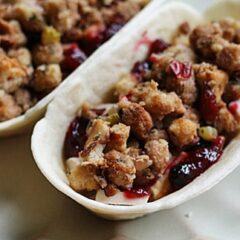 A close up photo of a turkey, cranberry and stuffing pockets.