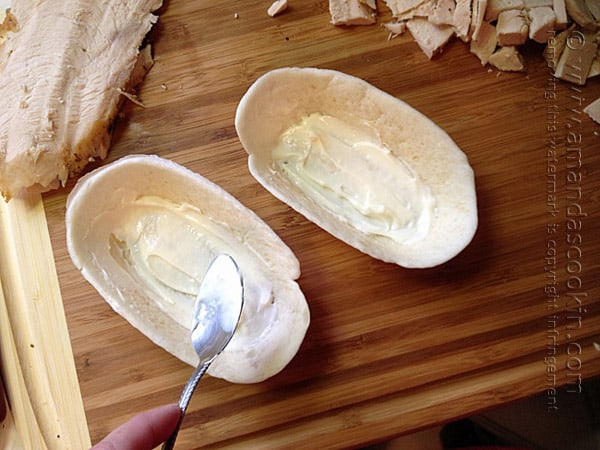 An overhead photo of mayonnaise being spread into stand n\' stuff tortillas. 