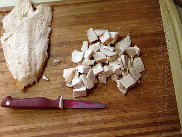 A close up photo of chopped turkey on a cutting board.