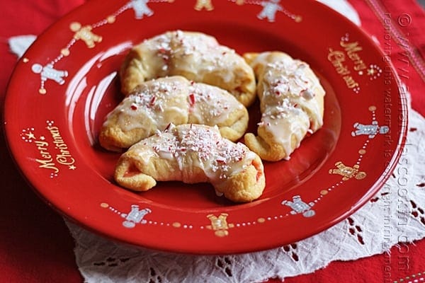 A close up overhead of a white chocolate candy cane crescents on a red plate.