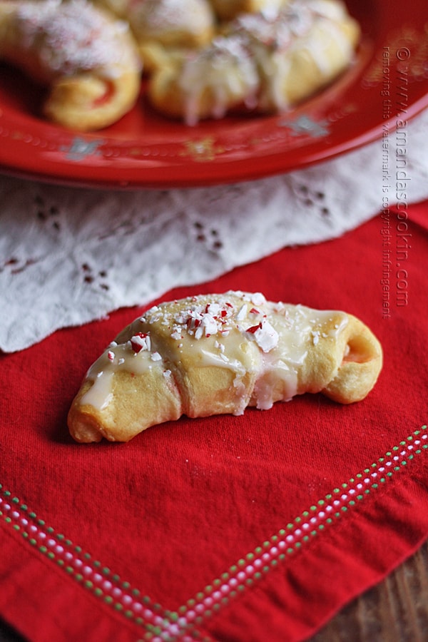 A close up photo of a white chocolate candy cane crescent on a red napkin.