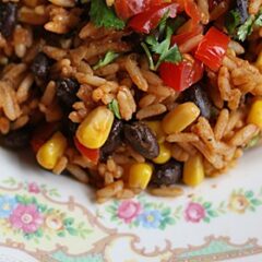 A close up photo of Spanish rice with black beans and corn.