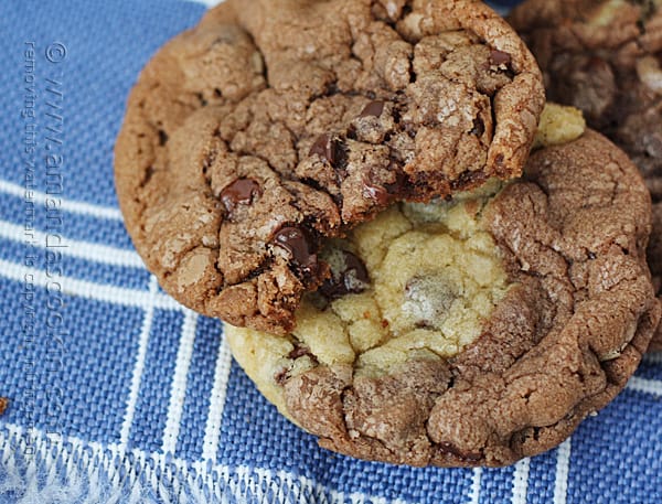 A close up photo of two pretzel chocolate chip cookies resting on a napkin.