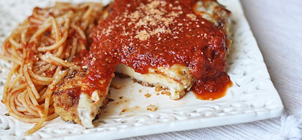 A close up photo of chicken parmesan.