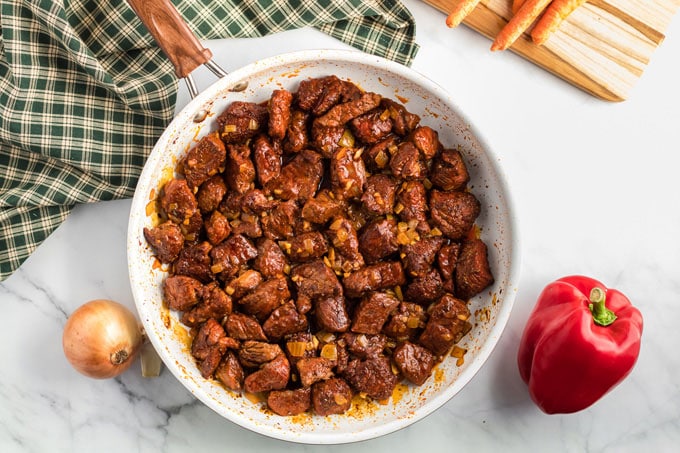 browned beef cubes in a skillet