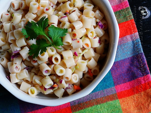 A close up overhead of three ingredient quick pasta salad in a bowl with fresh parley on top.