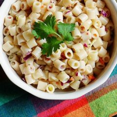 A close up overhead of three ingredient quick pasta salad in a bowl with fresh parley on top.